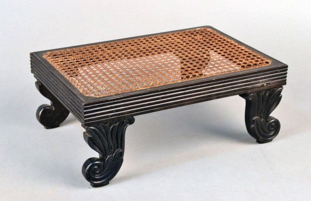 Anglo Indian Ebony and Caned Footstool: 19th century. Height 7 inches, width 16 1/2 inches, depth 11 inches.
