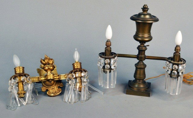Lamp and Wall Sconce: One brass two light lamp decorated with prisms, height 18 inches; along with a gilded bronze two arm wall sconce decorated with prisms, height 9 inches, width 16 inches.