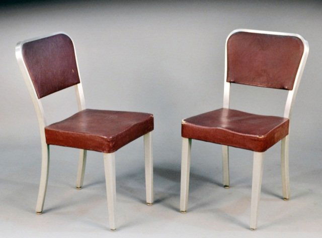 Set of Eight Goodform Aluminum Chairs: Each with maroon simulated leather upholstered back and seat. Height 31 1/2 inches, width 16 inches, depth 18 inches. Provenance: Historical Materialism, Hudson, New York