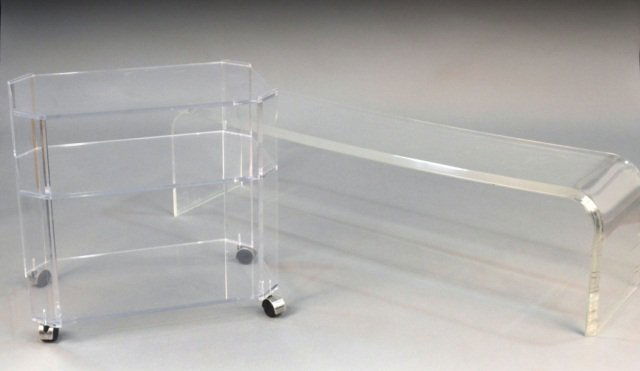 Two Lucite Tables: One, a rectangular coffee, height 16 1/2 inches, width 58 inches, depth 15 inches; together with a two tier side table, height 26 inches, width 27 1/2 inches, depth 16 1/2 inches.