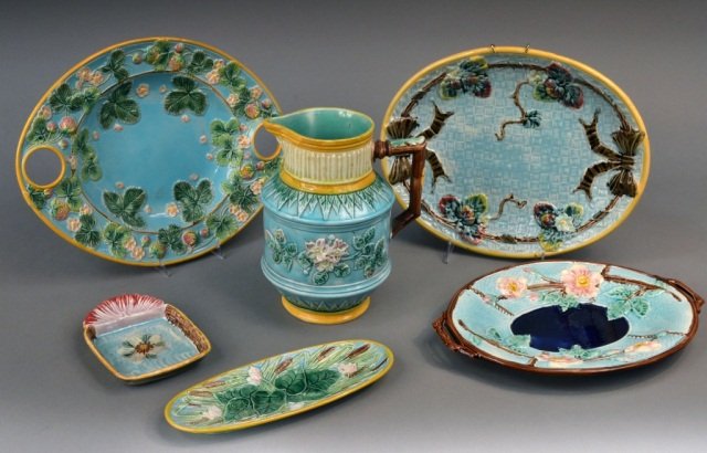 Miscellaneous Group of Majolica Table Articles: Various makers, comprising a pitcher, four oval trays, and a square dish. Pitcher, height 9 1/2 inches.