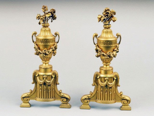 Pair of Bronzed Metal Andirons: Neoclassical style, each with a floral finial and draped with floral garlands. Height 15 inches.