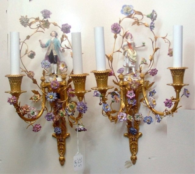 Pair of Caldwell Sconces: Two arm, each with porcelain figure and flowers on vine motif. Height 18 inches, width 9 inches.
