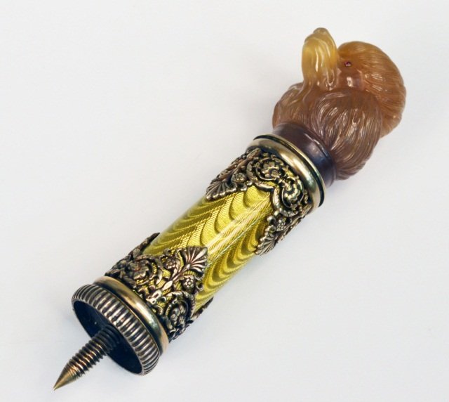 Russian Silver Enamel & Agate Dog Head Cane Handle: Poodle head with ruby eyes, mounted on a yellow enamel pedestal with scroll and leaf decoration. Height 4 1/4 inches.