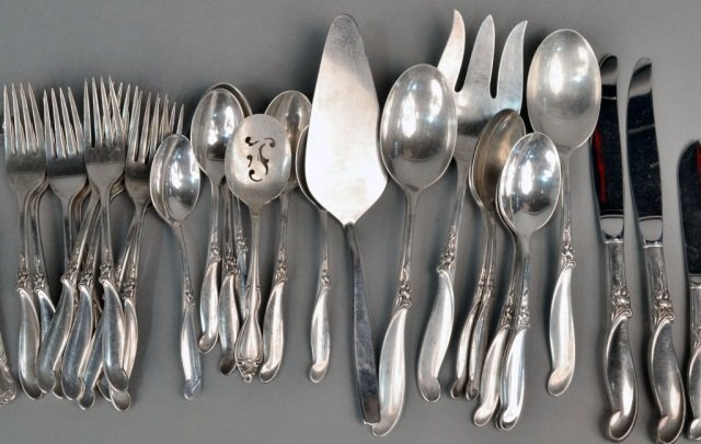 International Sterling Silver Flatware Service: Silver Melody pattern, comprising twelve dinner knives, twelve dinner forks, twelve spoons, twelve salad forks, twenty three teaspoons, five serving pieces and three additional silver plated flatware.