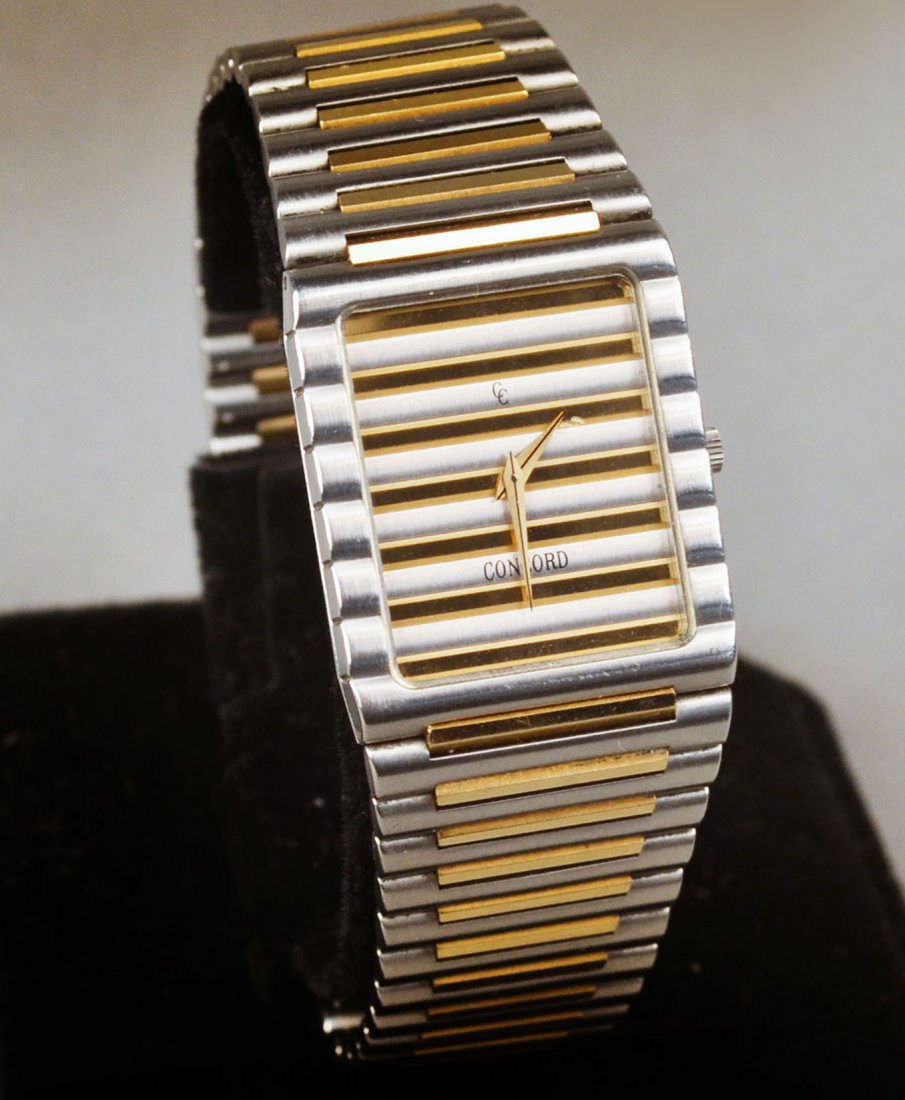Concord Gold and Stainless Steel Watch: Stainless steel and 14 yellow gold, water resistant watch, # 600245. Length 7 3/4 inches, in original box with papers.