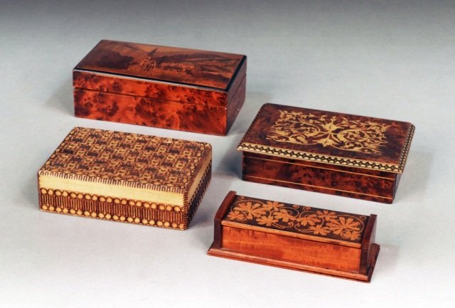 Group of Four Wood Trinket Boxes: Including carved and inlaid decoration. Largest height 2 inches, width 7 inches, depth 4 1/2 inches.