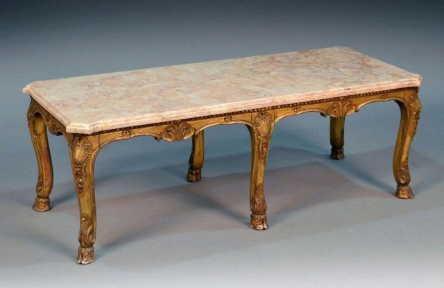 Marble Top Painted Coffee Table: Rectangular top with outset corners, on a Rococo style shell and floral carved gold painted base. Height 16 1/4 inches, width 46 1/2 inches, depth 19 1/2 inches.