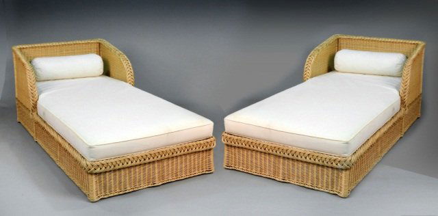 Pair of Rattan Chaises Longues: White upholstered cushions. Height 32 inches, length 6 feet 8 inches, depth 42 inches.