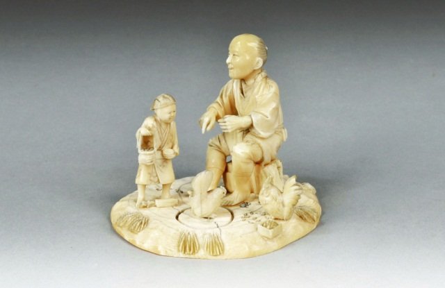 Japanese Carved Ivory Figure: Japanese Carved Ivory Figure Group Man seated with child and hen, signed. Height 4 1/4 inches.
