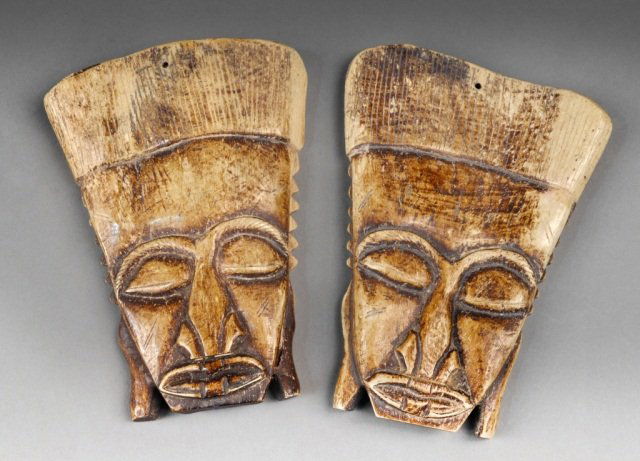 Pair of African Post Contact Wall Masks: Carved elephant bone. Height 8 inches.