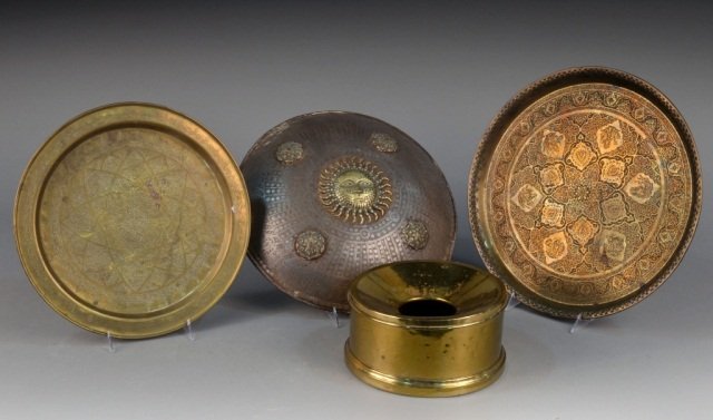Miscellaneous Group of Brass Decorations: Two circular trays and a shield with sun maks and rosette decoration. Shield, diameter 15 inches.