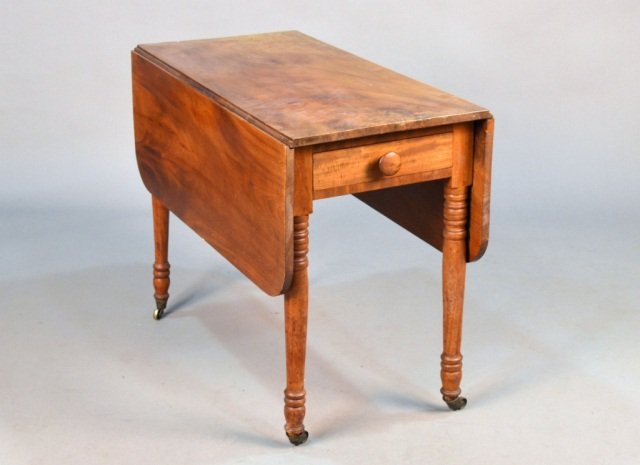 American Mahogany Drop Leaf Table: 19th century, rectangular top flanked by drop leaves, over a single drawer, turned tapered legs. Height 27 1/2 inches, width extended 44 inches.