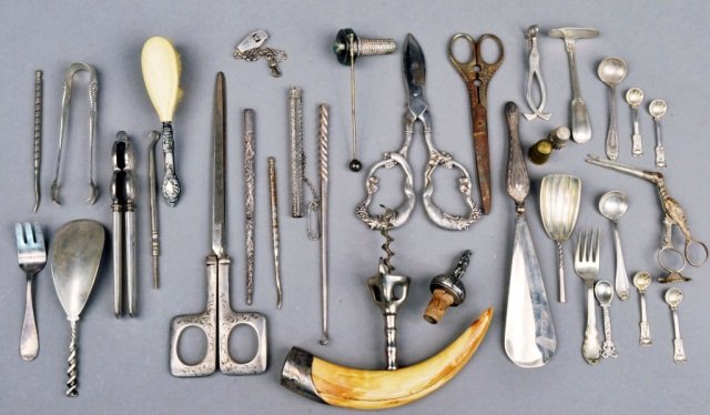 Group of Silver and Silver Plated Novelty Articles: Including a shoe horn, scissors, tusk cork screw, tongs, etc.