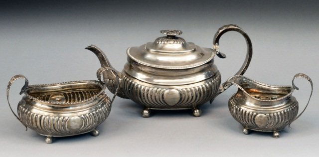 Georgian Silver Three Piece Tea Service: London, 1798, makers mark illegible, comprising teapot, milk jug, and sugar bowl. Height 6 1/2 inches. Provenance: Estate of Michael "Mendy" Wager.