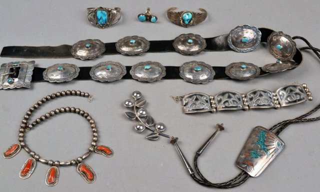 Group of Native American & Mexican Silver Jewelry: Including a leather belt with silver and turquoise medallions, a lariat, two turquoise and silver cuffs, bead necklace with coral, turquoise ring and a Mexican bracelet and pin.