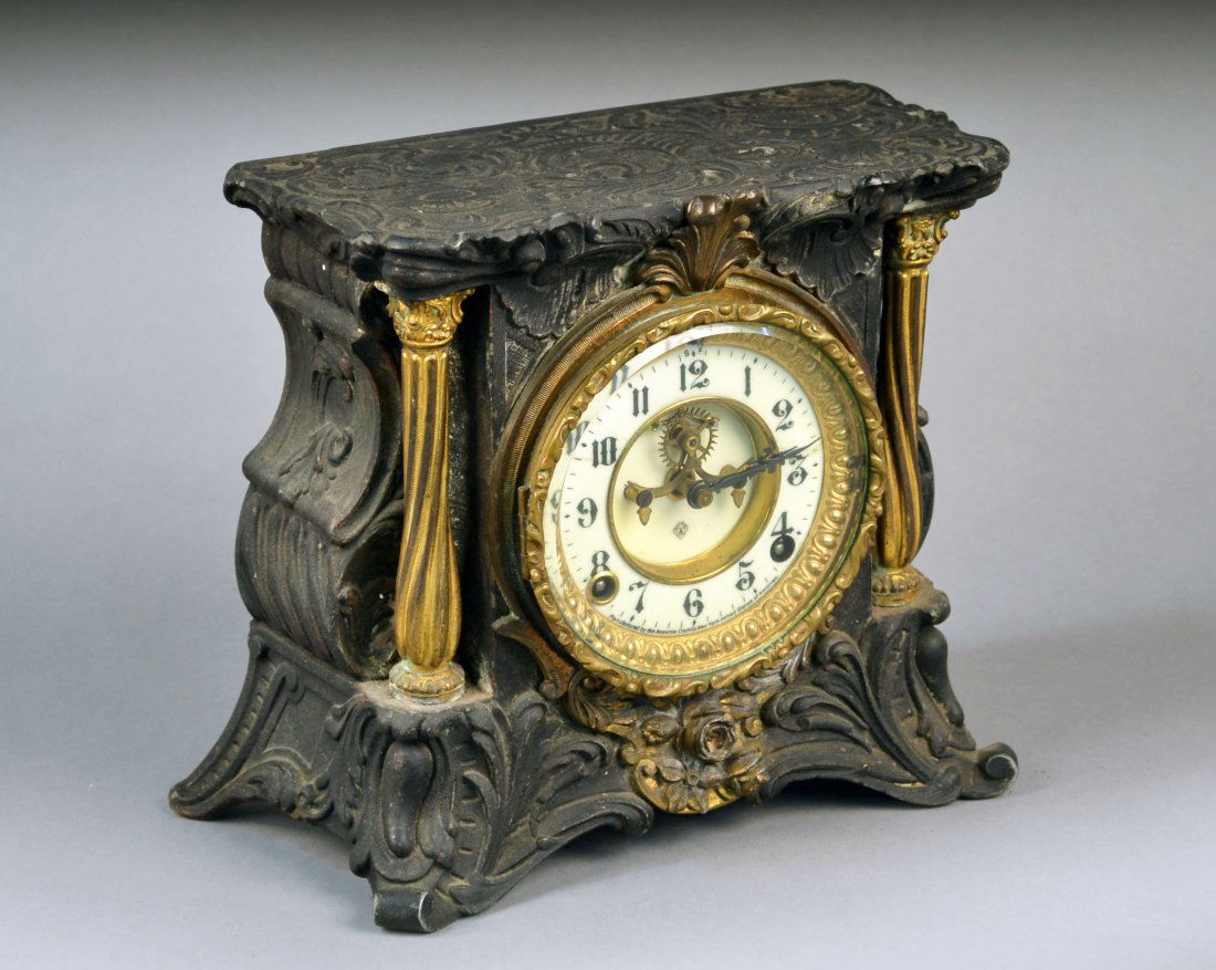 Ansonia Table Clock: Metal architectural case, enamel dial with Arabic numerals, outside escapement. Height 9 inches. Provenance: Estate of Michael "Mendy" Wager.