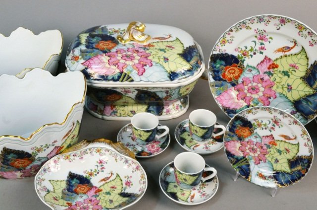 Mottehedeh Porcelain Tobacco Leaf Service: Comprising twenty four dinner plates, twenty four salad plates, twenty four cups and saucers, two shell form dishes, two cachepots, and a covered tureen. Dinner plate diameter 11 inches.