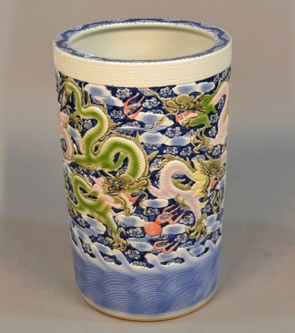 Chinese Ceramic Umbrella Stand: Cylindrical with all around dragon decoration. Height 24 inches, diameter 14 1/2 inches.