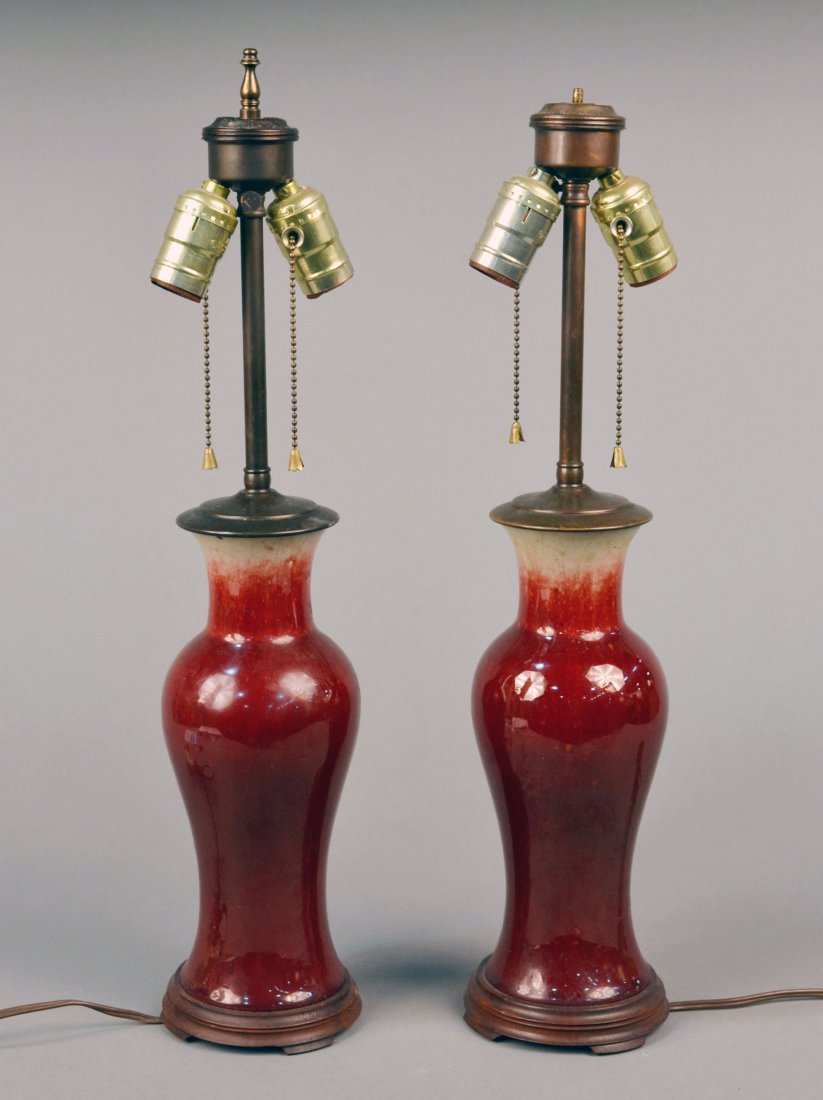 Pair of Asian Porcelain Two Light Lamps: Cylindrical neck, inverted baluster body, sang de boeuf glaze. Height 10 3/4 inches. Provenance: Estate of Michael "Mendy" Wager.