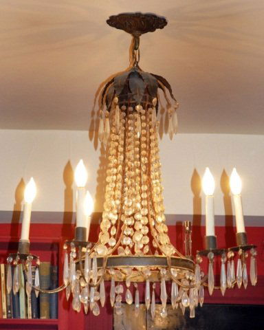 Neoclassical Style Chandelier: Painted tole and crystal six arm chandelier. Height 28 inches, diameter 28 inches. Provenance: Estate of Michael "Mendy" Wager.