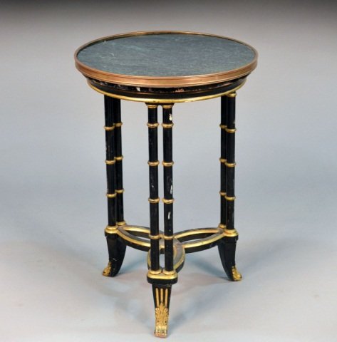 Marble Top Black Painted Gueridon: Green marble circular top on parcel gilt black painted faux bamboo legs joined by a shaped stretcher. Height 28 inches, diameter 19 inches. Provenance: From the set of "One Life to Live"
