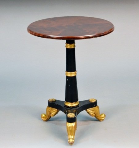 Mahogany Tripod Table: Circular top with molded edge on a partial gilt and black painted tapered column with a tripartite base on scroll feet. Height 26 1/2 inches, diameter 20 inches. Provenance: From the set of "One Life 
