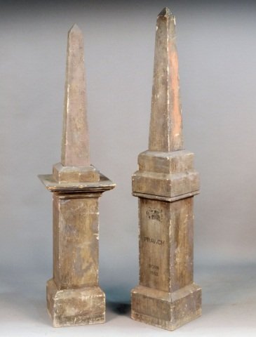 Two Faux Painted Composition Obelisk Gravestones: One, inscribed "Paravich / Born 1853"; the other unmarked. Taller height 6 feet. Provenance: From the set of "One Life to Live"