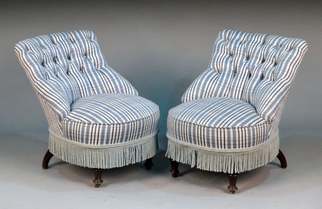 Pair of Upholstered Slipper Chairs: Blue and white striped upholstery, each with button tufted back and fringed trim. Height 28 inches, width 22 inches, depth 28 inches. Provenance: From the set of "One Life to Live"