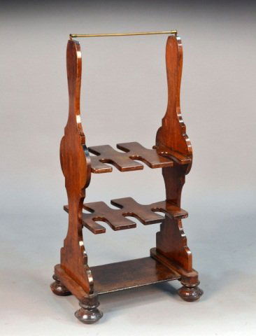 Victorian Mahogany Boot Rack: Brass bar above two boot racks on a trestle base with wing feet. Height 43 1/2 inches, width 20 inches, depth 15 inches. Provenance: From the set of "One Life to Live"