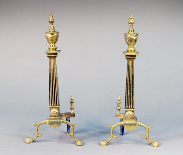 Pair of Neoclassical Style Brass Andirons: With urn form tops and footed. Height 22 inches.