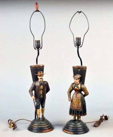 Pair of Tole Figural Lamps: Each with a single light and figural decoration, circular base. One depicting a man; the other depicting a woman. Height 24 inches.