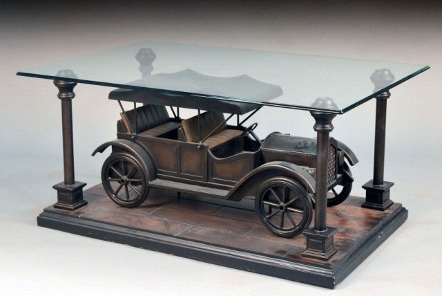 Glass Top Automobile Coffee Table: Rectangular glass top on a composition base in the form of a vintage automobile. Height 23 1/2 inches, width 50 inches, depth 32 inches.