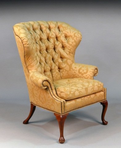 Baker Upholstered Lounge Chair: Damask upholstery, button tufted back, outscrolled arms, cushioned seat, and cabriole front legs ending in pad feet. Height 46 inches, width 36 inches, depth 36 inches.
