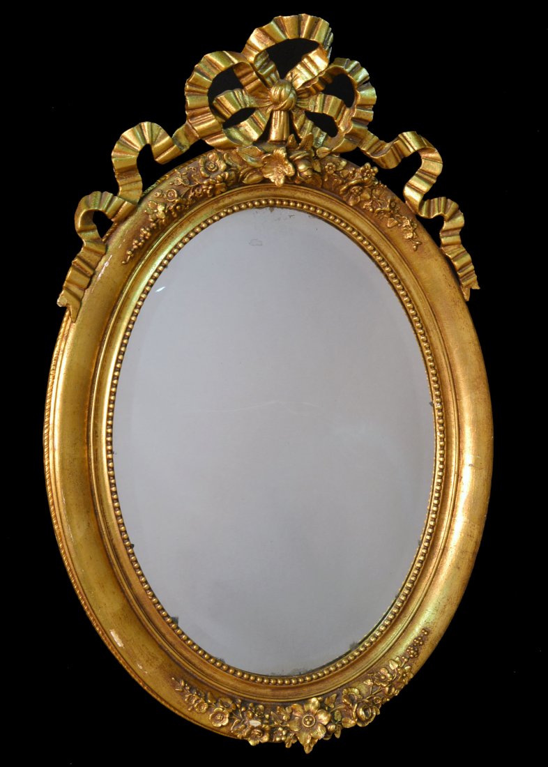 Neoclassical Style Oval Mirror: Floral and tied bow ribbon decoration. Height 43 inches, width 30 inches.