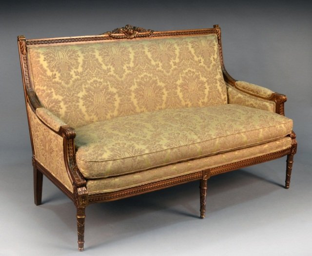 Louis XVI Style Gold Painted Settee: Rectangular damask upholstered back, padded arms and cushion seat on tapered front legs with reed and tie carved decoration. Height 40 1/2 inches, width 62 inches, depth 36 inches.