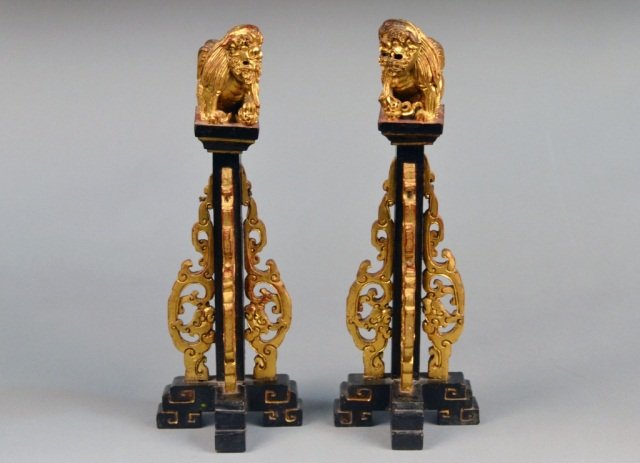 Pair of Chinese Gilded Wood Altar Decorations: Each a column with gilt scroll decoration surmounted by a lion. Height 14 1/2 inches.