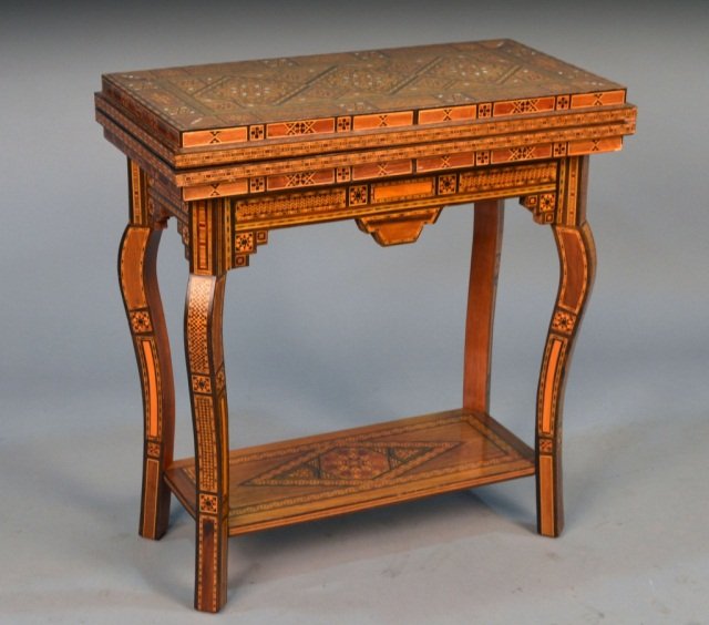 Syrian Game Table: Inlaid geometric decoration, cabriole legs joined by a lower shelf. Height 30 inches, width 28 1/2 inches, depth 14 1/2 inches.