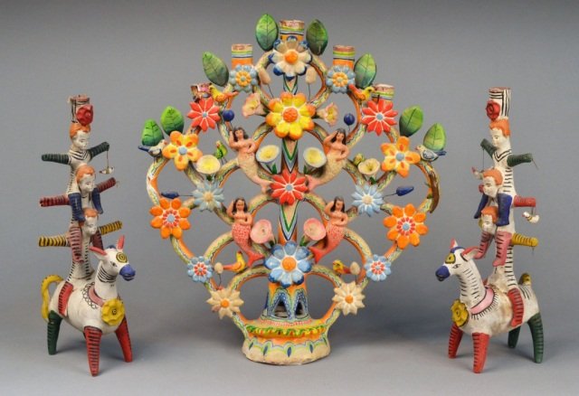 Mexican Pottery Candelabrum & Pair of Candlesticks: Candelabra decorated with figures, flowers and birds; the two figural candlesticks modelled as a three stacked on a donkey. Candelabrum, height 20 3/4 inches, width 18 1/2 inches. Pair of candlesticks