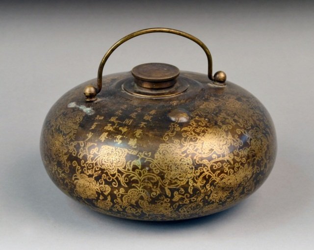 Chinese Mixed Metal Bed Warmer: Flattened globular shape with gilt decoration of flowers, swing handle. Height over handle, 5 inches, diameter 7 inches.