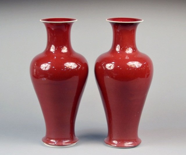 Pair of Chinese Porcelain Vases: Each sang de boeuf baluster form vase with everted rim, waisted neck and inverted baluster body. Height 17 inches.