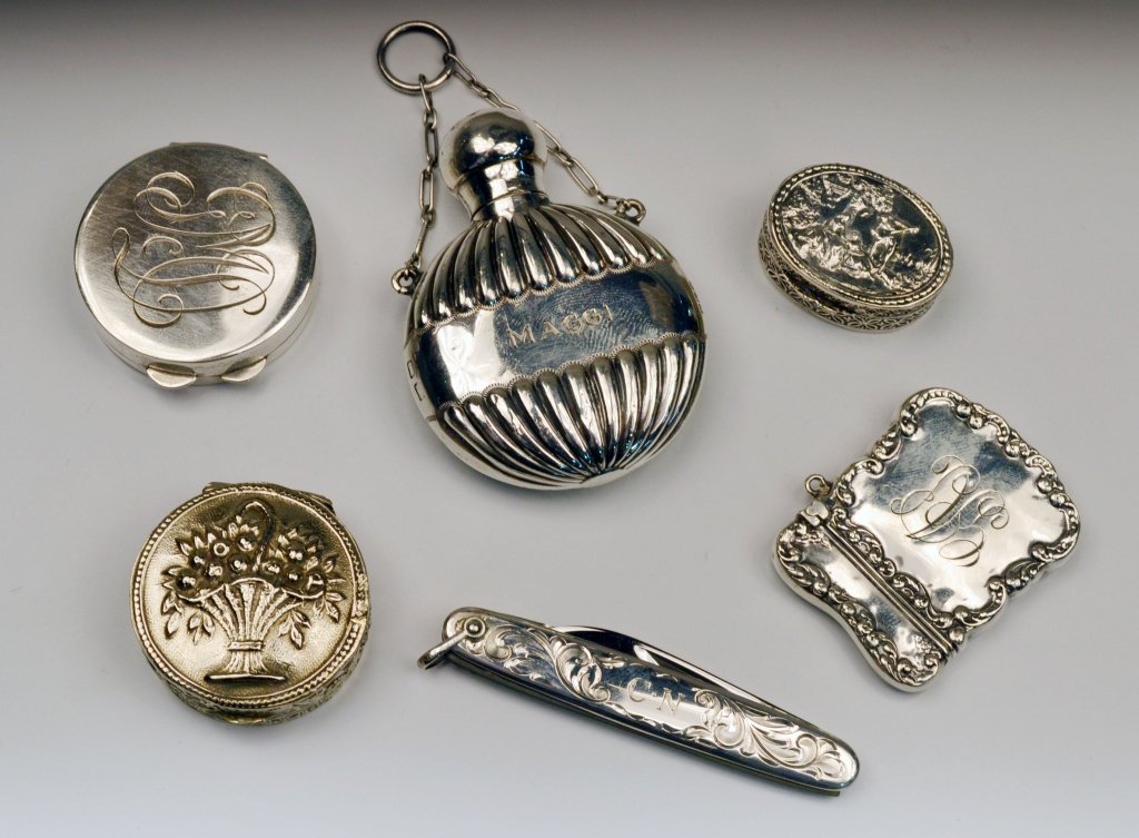 Miscellaneous Group of Sterling Silver Articles: Comprising a Tiffany & Co. pen knife, an English silver perfume bottle, three silver pill boxes, and a match safe. Total approximately 5 ounces, weighable.