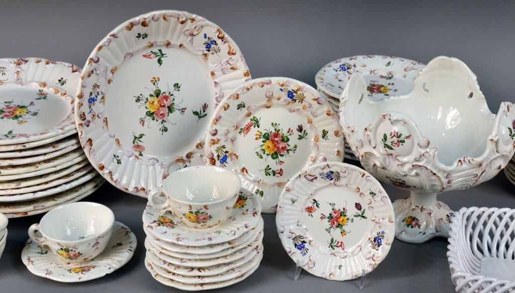 Italian Pottery Dinner Service: Floral decoration, comprising twelve dinner plates, twelve salad plates, nine bread plates, nine cups, ten saucers, compote, all together with a square pottery basket. Dinner plate diameter 10 1/2 inc