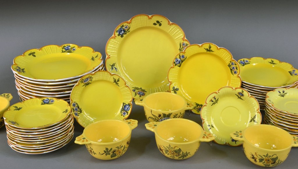 French Yellow Pottery Service: Painted floral decoration, comprising twelve dinner plates, twelve salad plates, twelve bread plates, thirteen saucers, and six soup cups. Dinner plate diameter 11 inches.