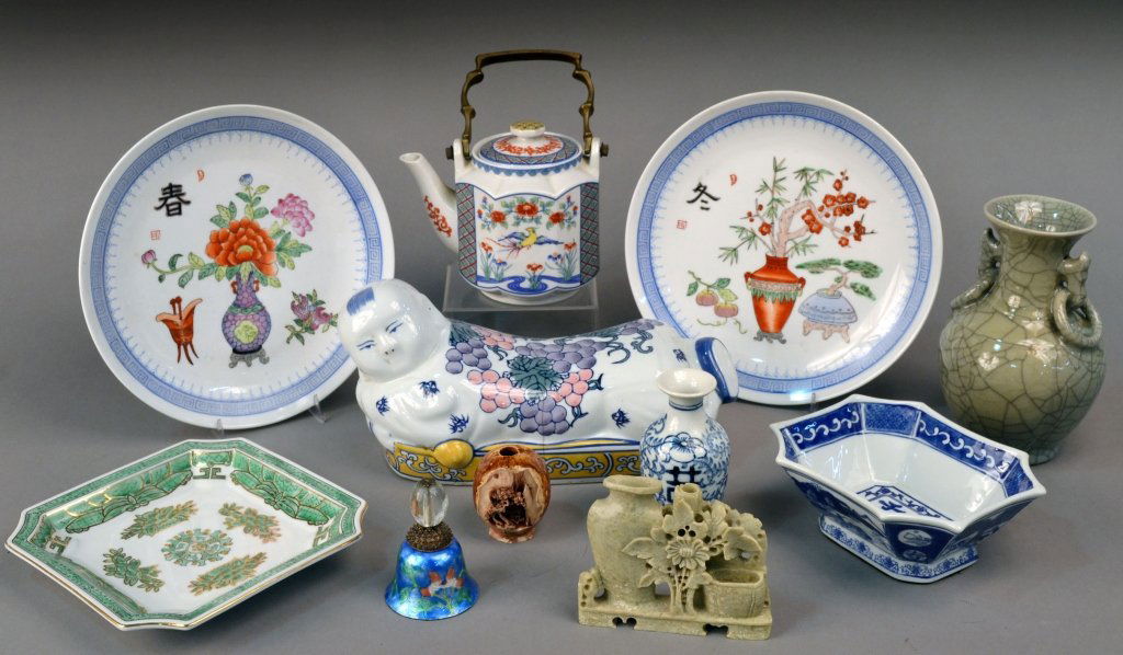 Group of Assorted Asian Porcelain Table Articles: Including a pair of blue and white decorated plates, tea pot, blue and whit bud vase, porcelain pillow, etc.