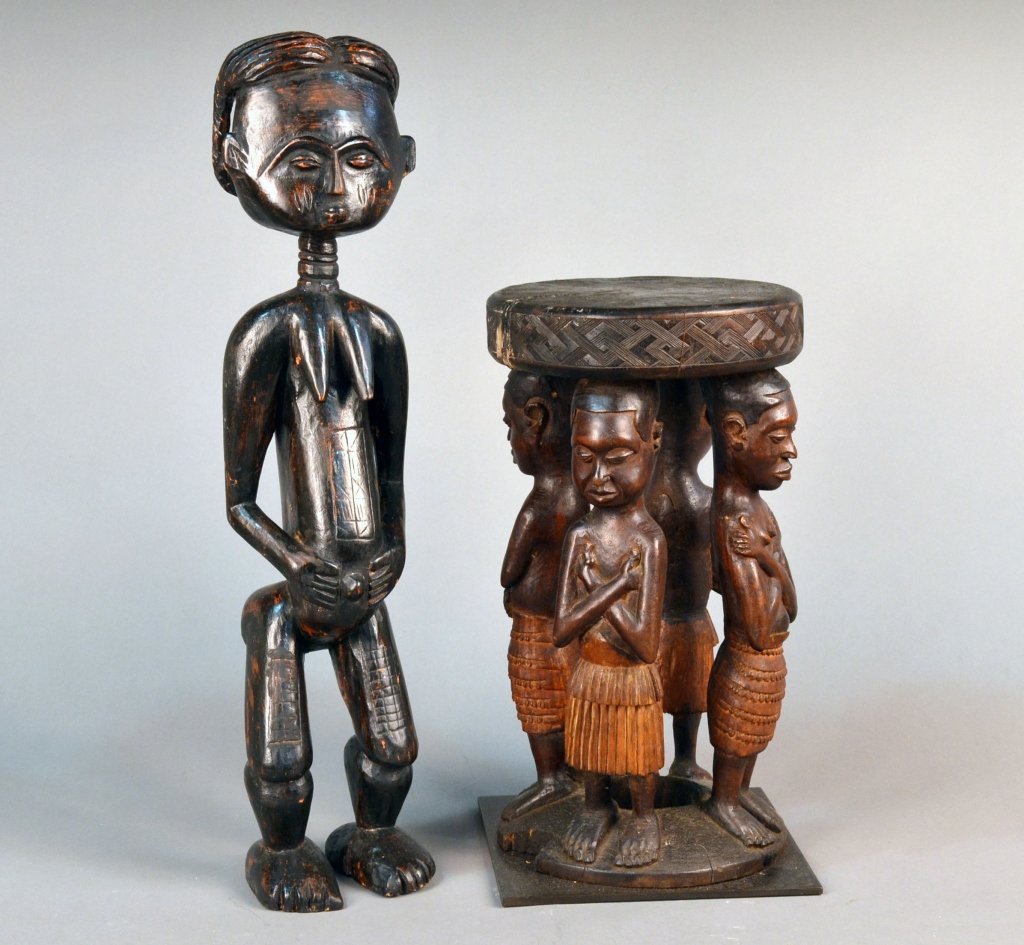 African Carved Wood Fertility Figure: Baule tribe male figure carved standing, height 28 inches; together with a figural stool, height 19 1/2 inches.
