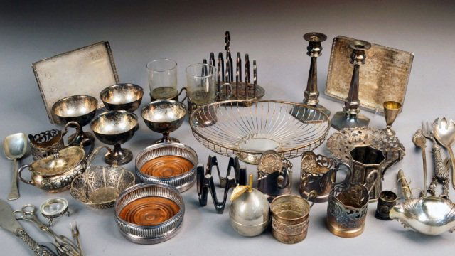 Miscellaneous Group of Silver Plated Articles: Including pair of candlesticks, two handle serving tray, pair of small trays, pair of wine coasters, toast rack, flatware, etc.