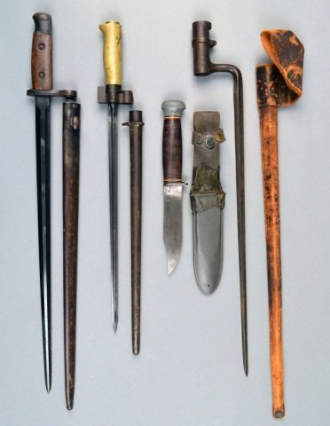 Miscellaneous Group of Three Bayonets: Including examples from 19th and 20th centuries, all with sheaths; together with a USN Mark II combat knife by PAL with sheath. Longest blade length 17 1/2 inches.