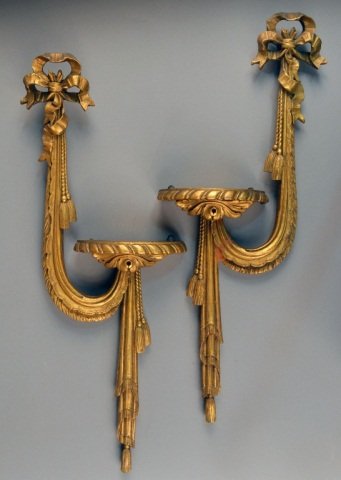 Pair of Gilt Wood Brackets: Neoclassical style, each with ribbon and tassel decoration. Height 24 inches.
