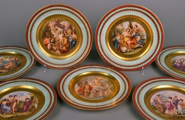Set of Seven Royal Vienna Style Cabinet Plates: Each with gilt, green, maroon and white border with raised gilt decoration, all featuring allegorical scenes, some signed. Each with Royal Vienna mark and title over glaze. Plate diameter 10 5/8 inche